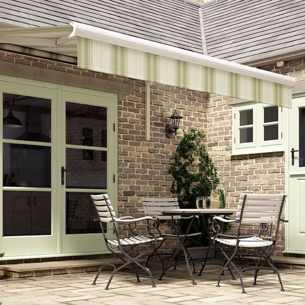 An extended awning in Rome Green fabric covering a outdoor area