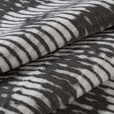 Black and white striped Cadillac Noir swatch on a ream of fabric