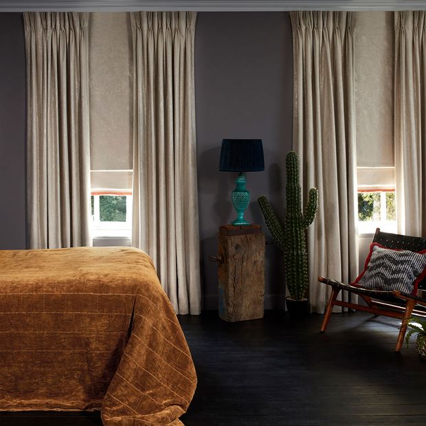 Bedroom with edgy decor and neutral Curtains in Abigail Ahern Lucien Dust fabric layered with Lucien Dust Roman Blind with a Colette Amour Orange Fringing