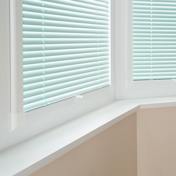 Close up of perfect fit blinds in pastel green fabric