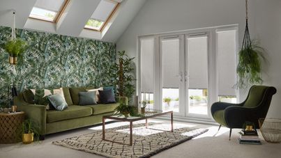 Living room with tropical design and patio doors dressed with grey perfect fit blinds