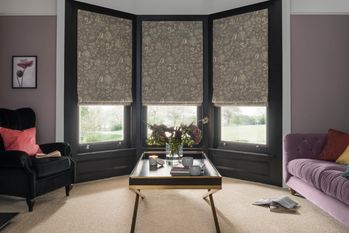 living room with oralia dove roman blinds in bay window