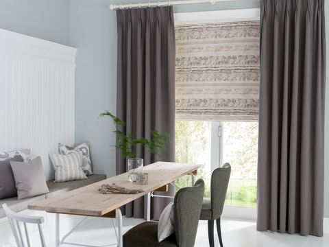 Dining room with Tetbury Charcoal curtains and Fjord Dusk Roman blinds