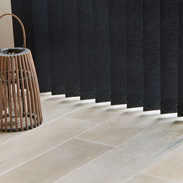Close up of full length charcoal black vertical blinds