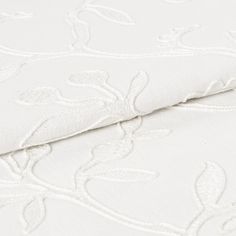White coloured fabric of Adhara Whisper with detailed stem design woven into the material