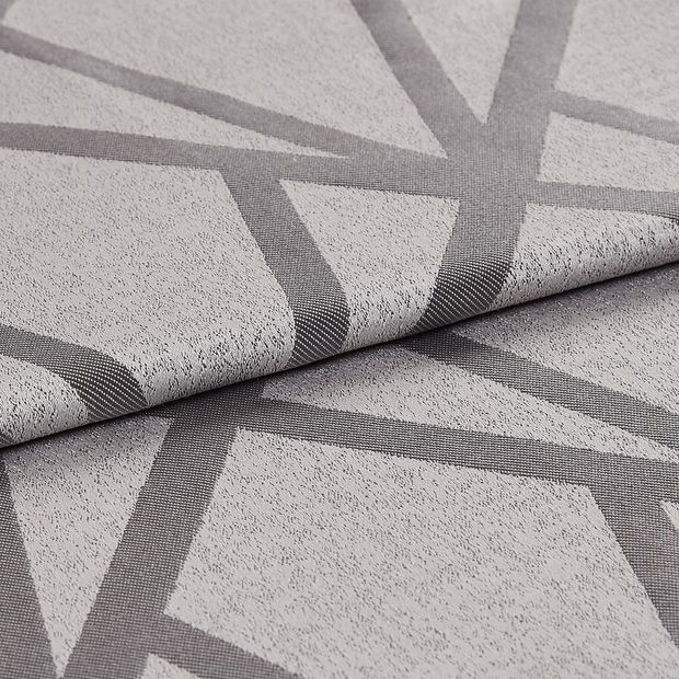 Folded fabric that has a light grey base grey and dark grey geometric lines