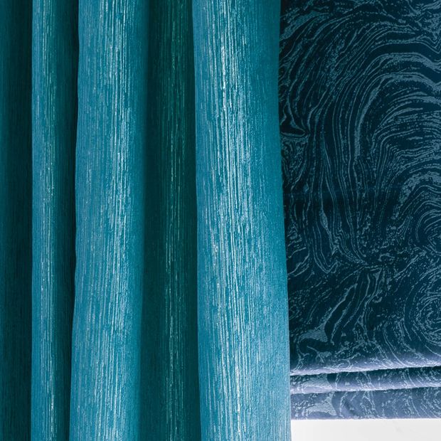 Close up of Surface Peacock curtains and Muse Deep Lapis romans in living room