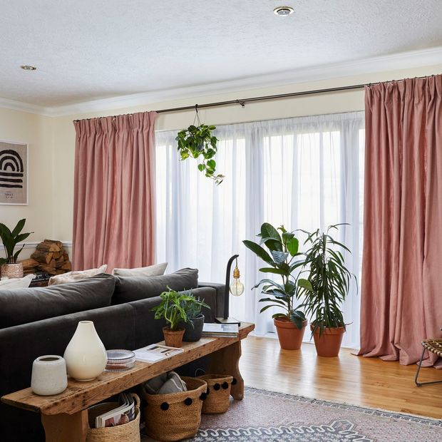 Living room with large sliding doors dressed in voiles and curtains