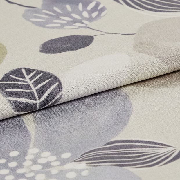 Beige coloured fabric with dark and white styled flowers