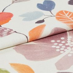 flowers decorated in a variety of watercolours on crisp white base material in a repeating pattern