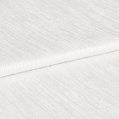 White coloured fabric with highlights in a darker shade that gives the material a textured look