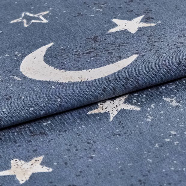 dark blue folded fabric with a repeating pattern of stars and moon in a white colour