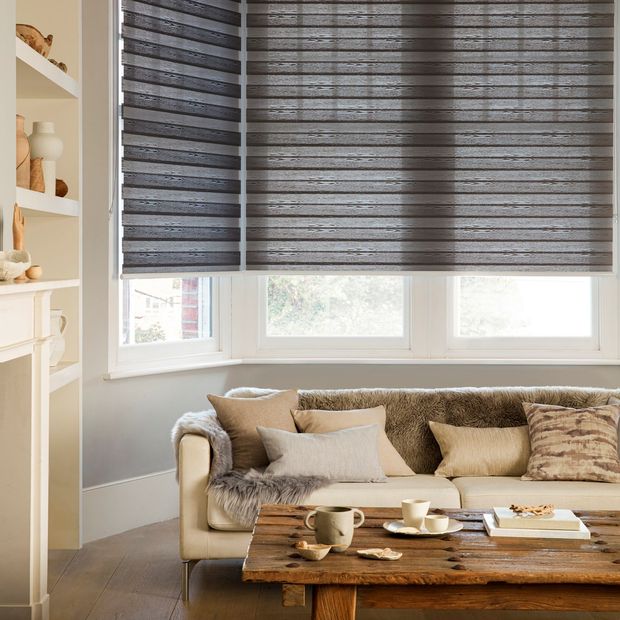 Close up of a golden coloured living room with taupe coloured blinds