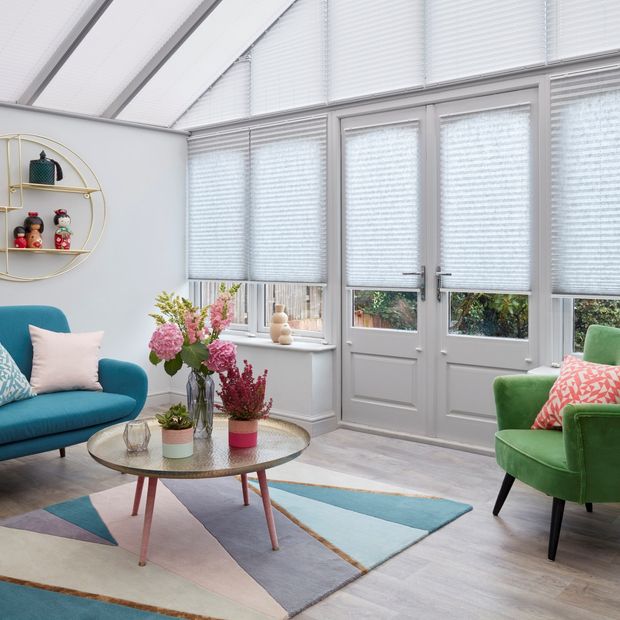 Natural pale grey Pleated blinds dressed on doors and windows, with white Highgrove Pleated blinds on the conservatory roof.