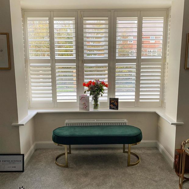 Front on shot of bay window featuring white full height shutters