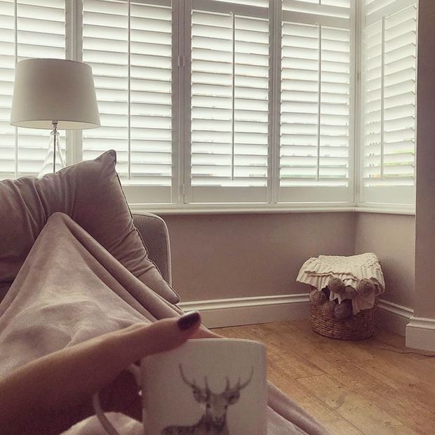 full height shutters installed on windows of living room