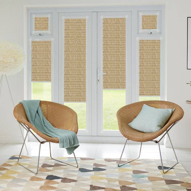 Sitting room doors showing Brown Luster Dark Bronze Perfect Fit Pleated blinds. The blinds sit on two door panes and two window panes, with small amounts of light able to creep through into a modern sitting area decorated in a minimalist style.