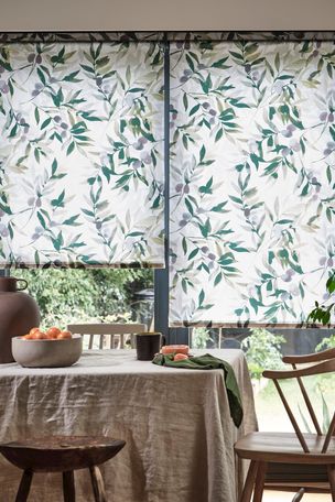 An earthy dining room with a white and green blind and fitting furnishings