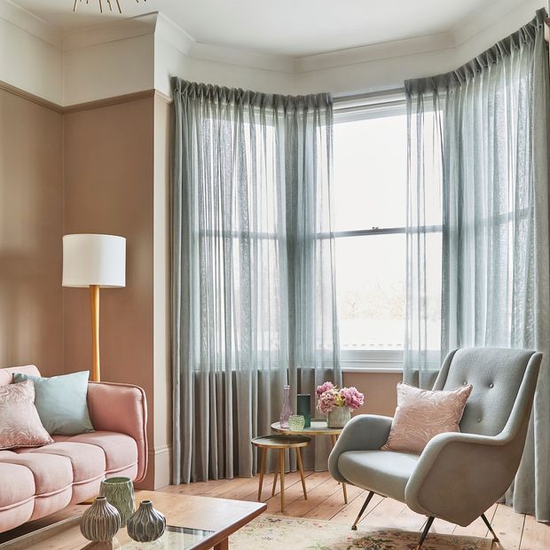 Serenity seaglass voile curtains in 3 sided sash bay window with link pink sofa and pastel coloured accessories