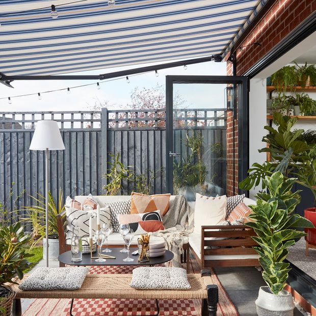 Rome Blue awning covering outdoor furniture with green plants for decoration