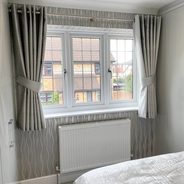 Grey eyelet curtains in a bright, modern curtains