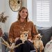 Lara Hall sat in her home with her dogs and white cafe shutters