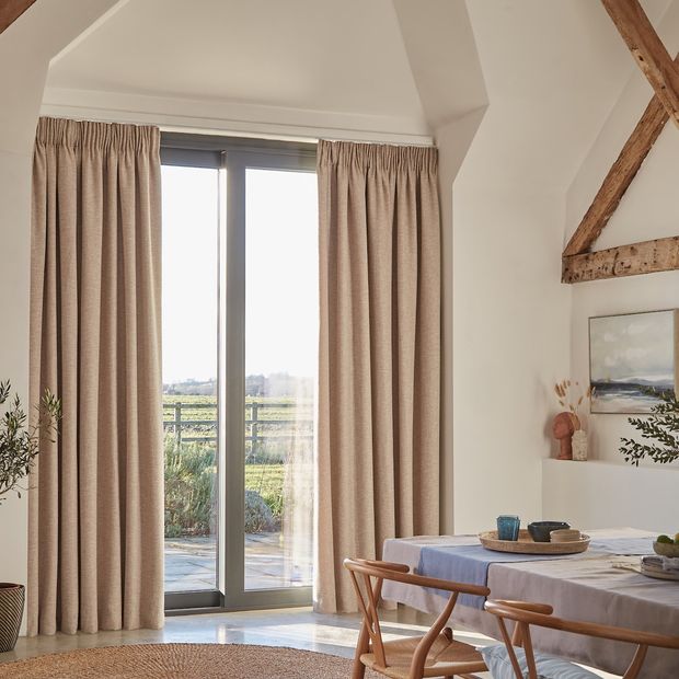 Nest Almond curtain opened in a lounge window