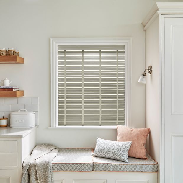 Faux wood venetian blinds with tapes in ellwood flint grey shade on a home office window