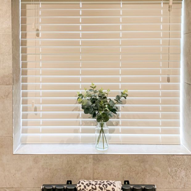 zen white oak faux wood venetian blinds in bathroom above small radiator