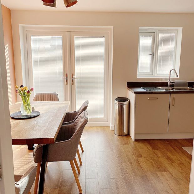 portfolio white perfect fit venetian blinds on patio door in dining room/kitchen