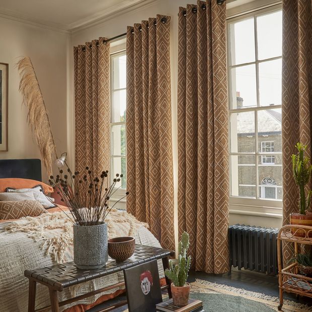 Oriel Sepia curtains in a bedroom
