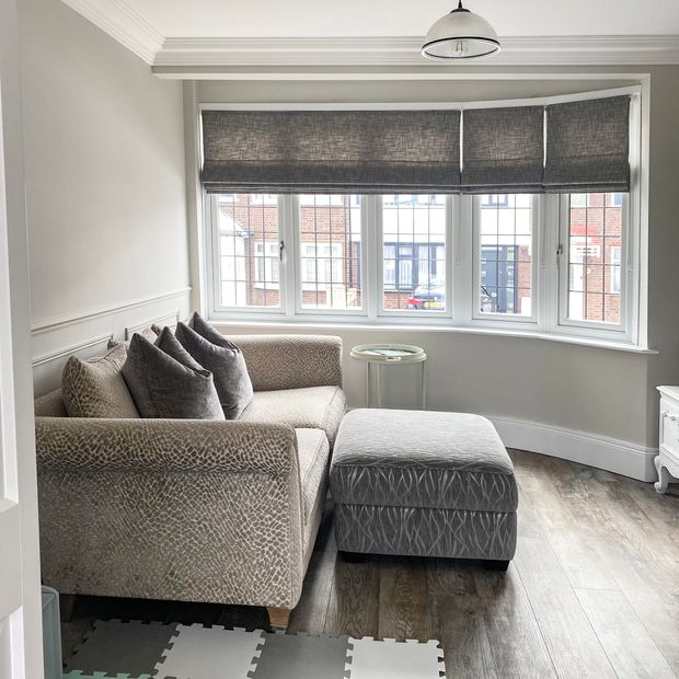 Allure state roman blinds on a bay window in a beige lounge