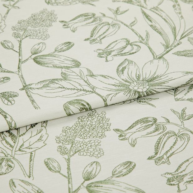A folded piece of fabric with Anika Green printed on it