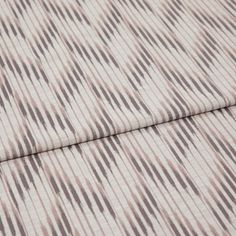 A folded piece of fabric with Diffuse Rose Blush Pink printed on it