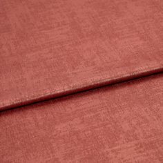 A folded piece of fabric with Dusk Aragon Orange printed on it