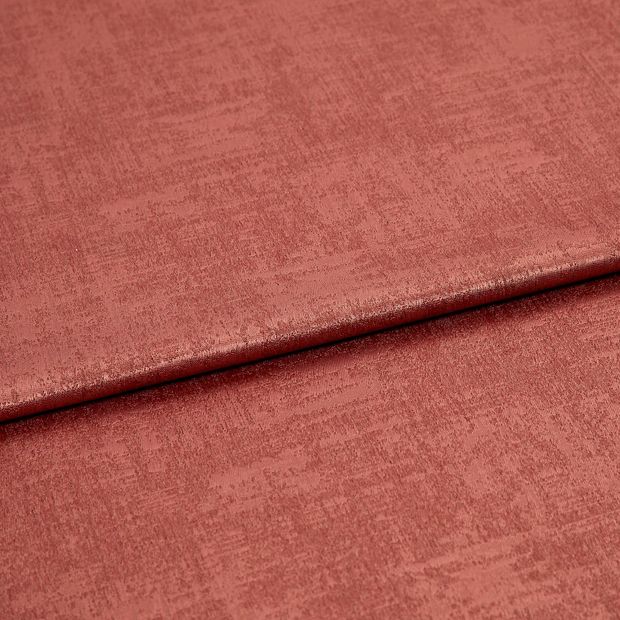 A folded piece of fabric with Dusk Aragon Orange printed on it