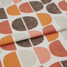 A folded piece of fabric with Burt Rust Orange printed on it