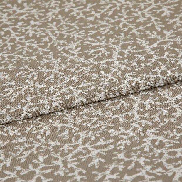 A folded piece of fabric with Coral Oyster Brown printed on it