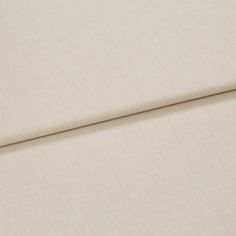 A folded piece of fabric with Harper Almond Cream printed on it