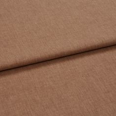 A folded piece of fabric with Harper Canyon Orange printed on it