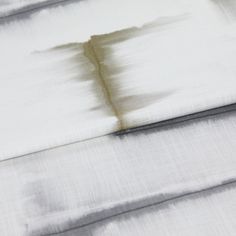 A folded piece of fabric with Expression Sombre Grey printed on it