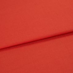 A folded piece of fabric with Faso Fiesta Red printed on it
