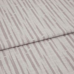 A folded piece of fabric with Flourish Lilac printed on it