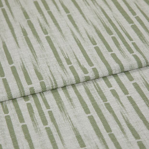 A folded piece of fabric with Flourish Sage Light Green printed on it