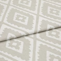 A folded piece of fabric with Mali Husk Cream printed on it