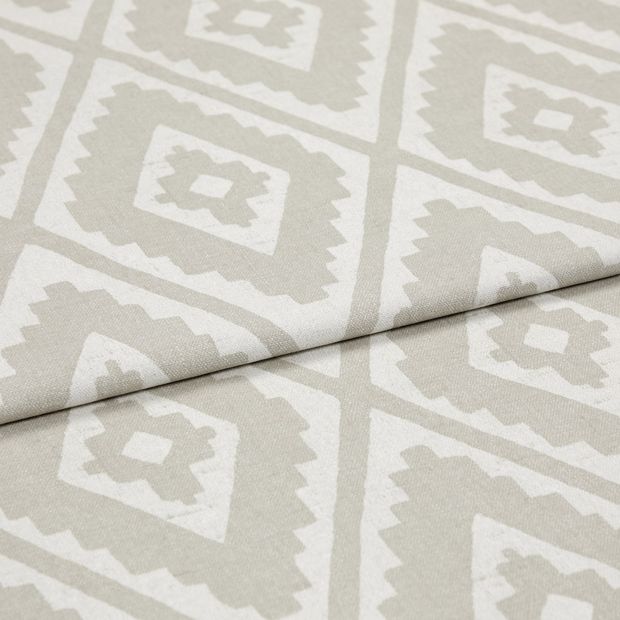 A folded piece of fabric with Mali Husk Cream printed on it