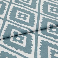 A folded piece of fabric with Mali Peacock Teal printed on it