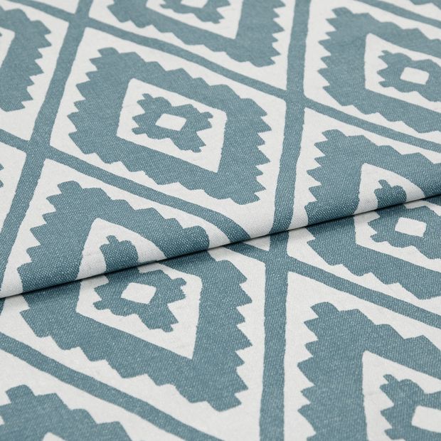 A folded piece of fabric with Mali Peacock Teal printed on it