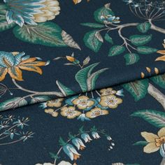 A folded piece of fabric with Manisha Forest Green printed on it
