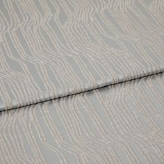A folded piece of fabric with Maud Mineral Silver printed on it